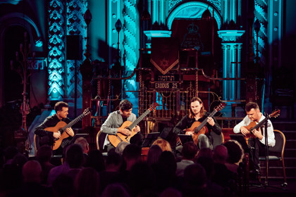 Australian Guitar Quartet on stage playing guitar